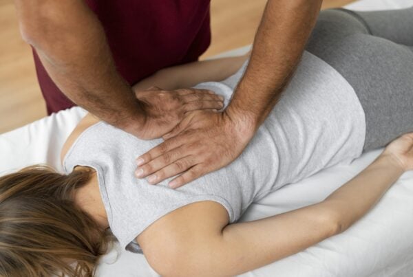 Chiropractor performing gentle spinal adjustment to relieve everyday pain and improve posture.