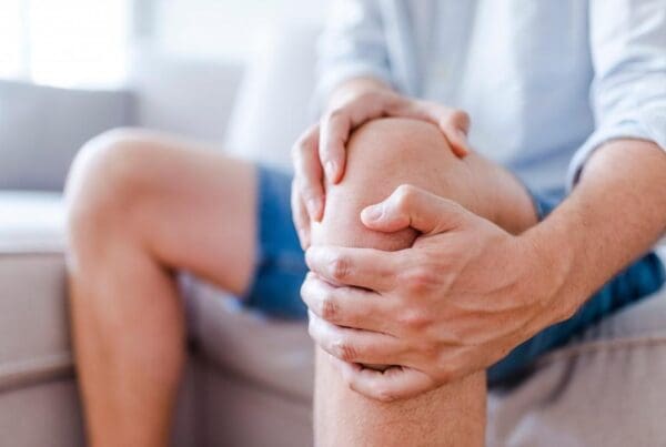 Person experiencing knee pain while walking, with potential causes beyond arthritis being evaluated